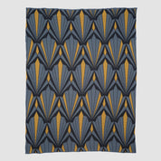 The In2Green Art Deco Shells Throw Blanket is a rectangular luxury throw with a repeating geometric Art Deco pattern in blue, grey, and yellow.