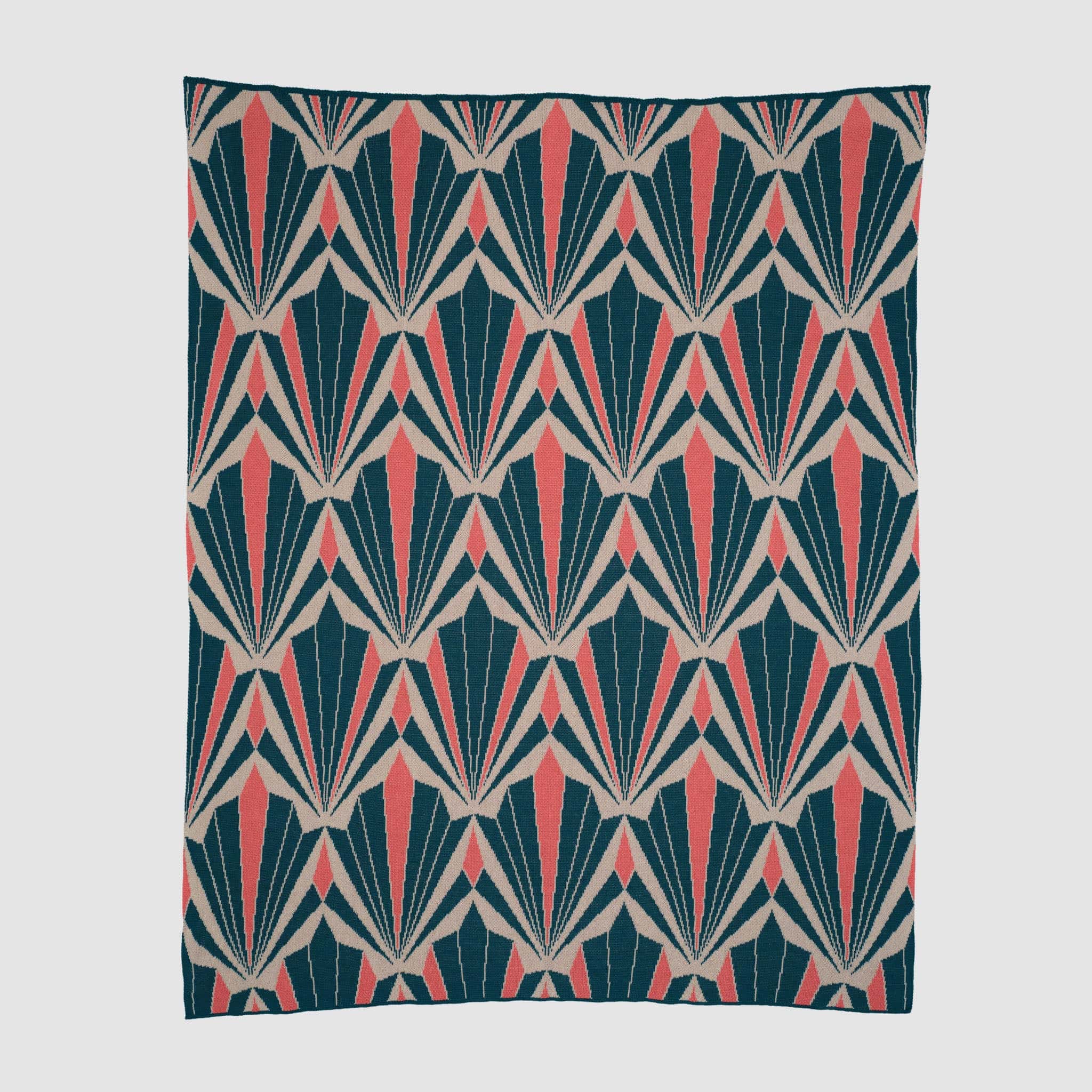 The Art Deco Shells Throw Blanket by In2Green showcases a repeating geometric pattern in navy blue, beige, and coral with stylized shell motifs, evoking classic Art Deco style.