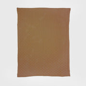 The in2green Basketweave Throw Blanket, rectangular and light brown, made from sustainable recycled yarns, is displayed flat on a white background.