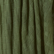 A close-up of the in2green Basketweave Throw Blanket, made with recycled yarns, highlights its detailed basket weave pattern and textured surface for a sustainable accent.