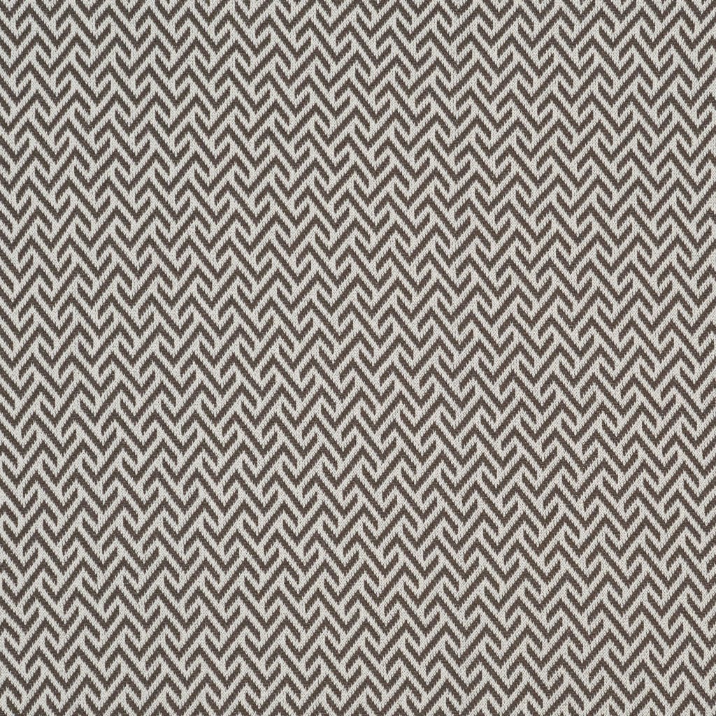 A close-up of the in2green Broken Zig Zag Throw Blanket highlights its intricate knit texture and cozy design.