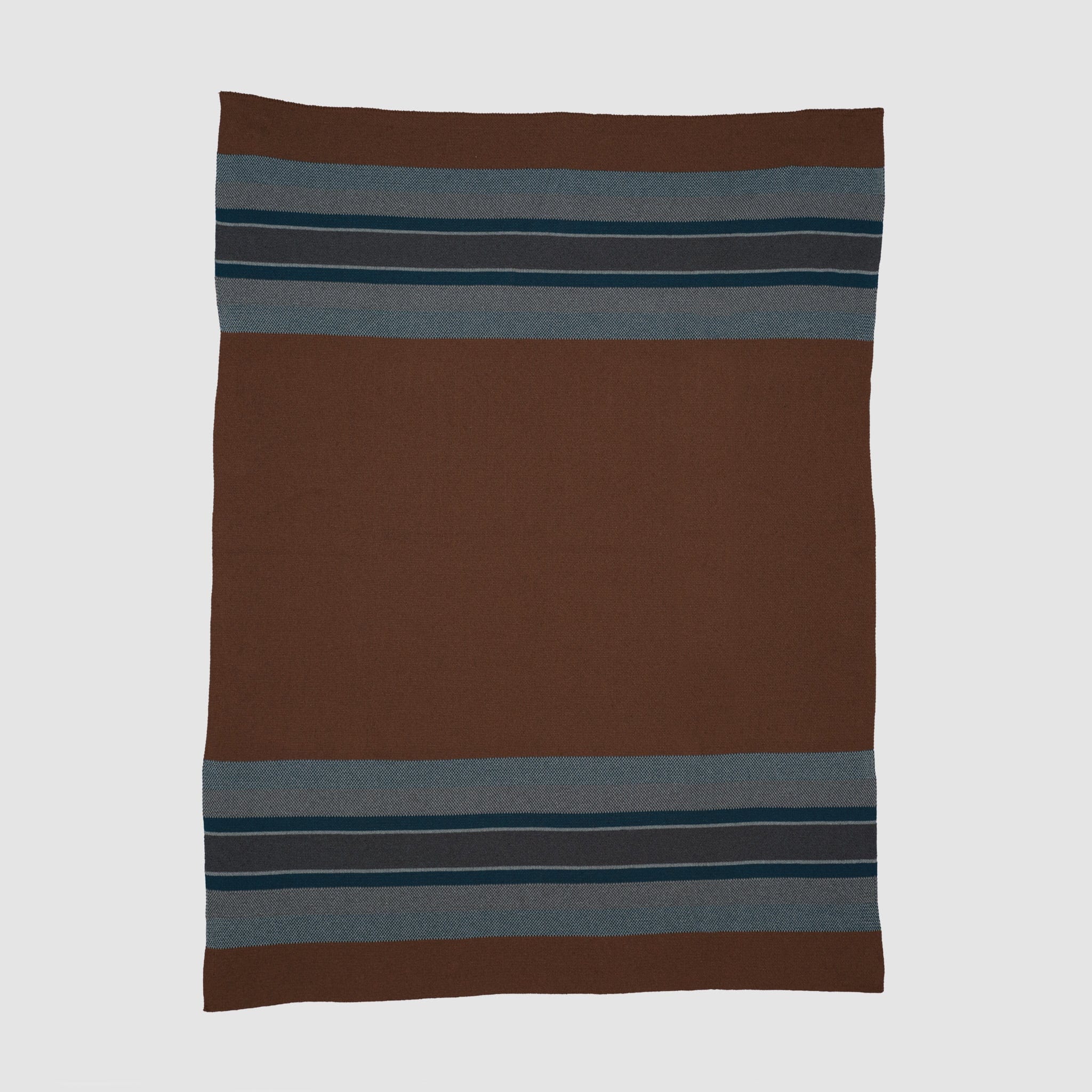 Brown blanket with rustic blue and navy stripes near the edges.