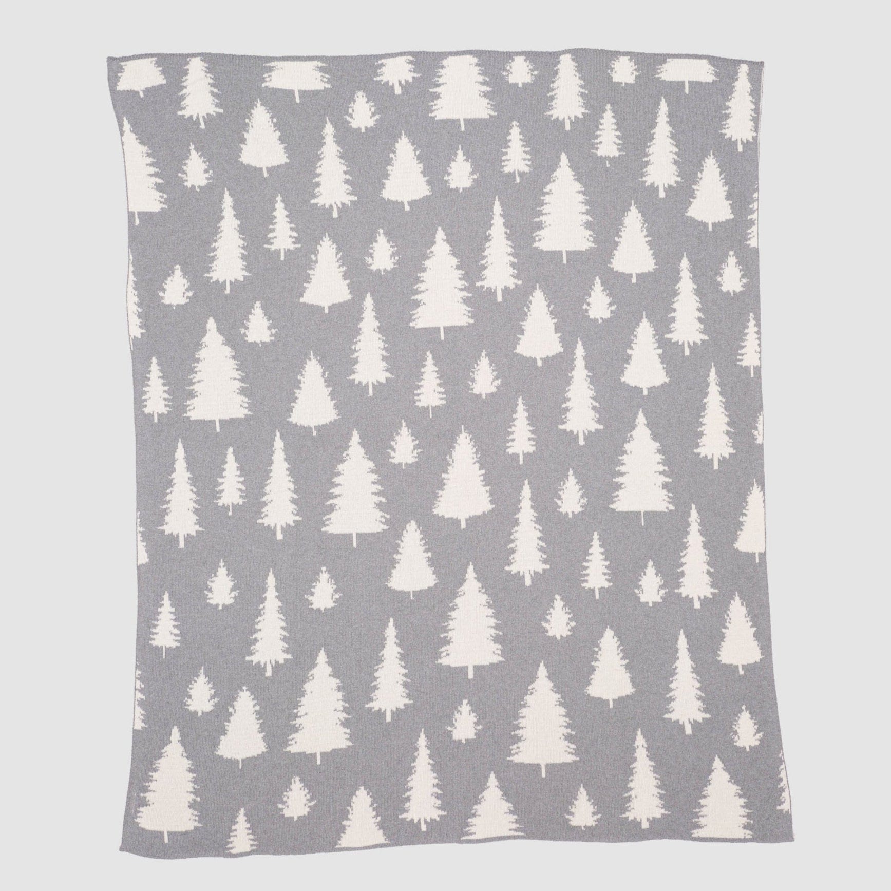The in2green Fir Trees Reversible Throw Blanket features a grey background with white evergreen tree patterns in varying sizes, offering cozy style and versatility to any space.