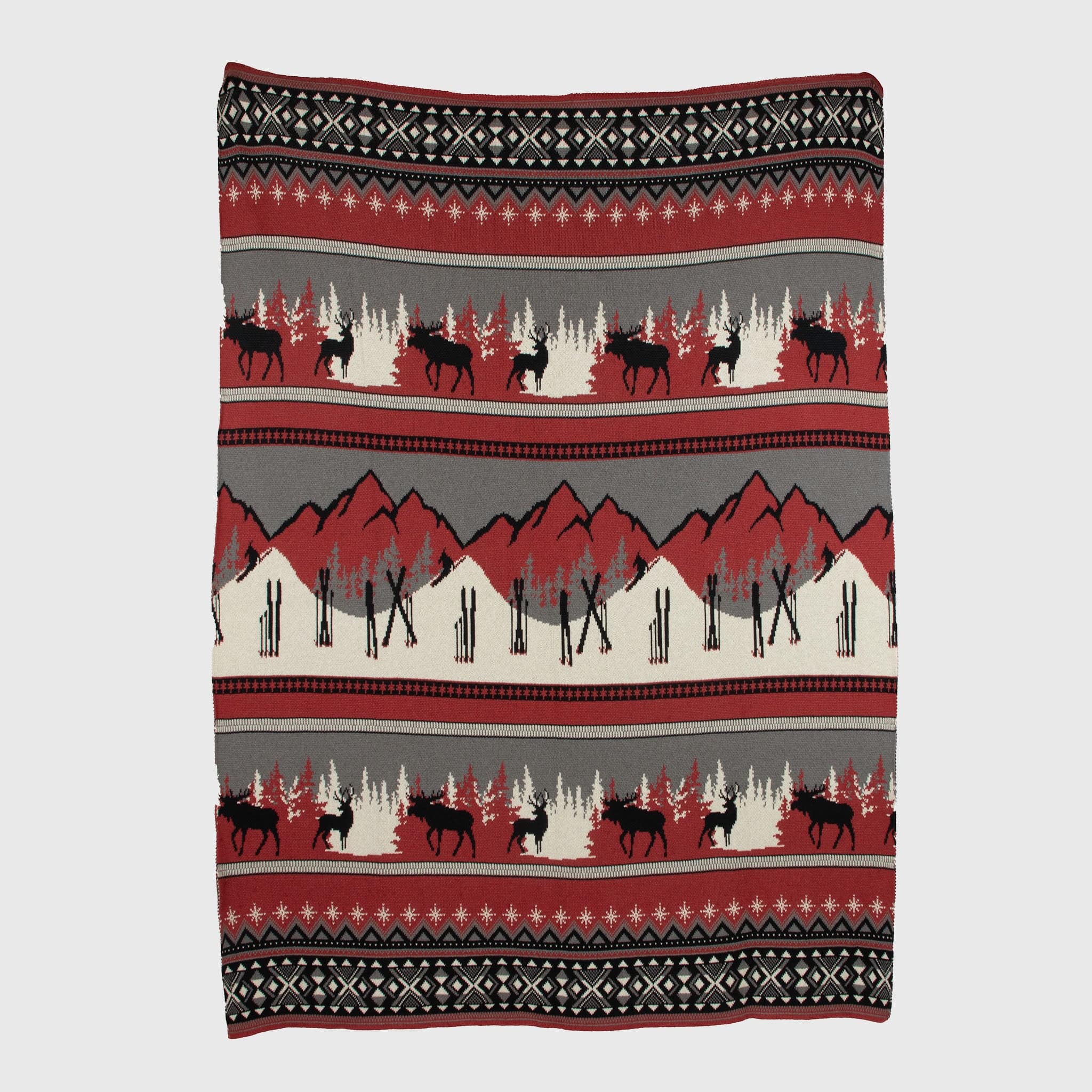 The Mountain Fair Isle Throw Blanket, made from recycled cotton, showcases red, black, and beige bands with moose, trees, mountains, and geometric patterns—ideal for cozy holiday décor.