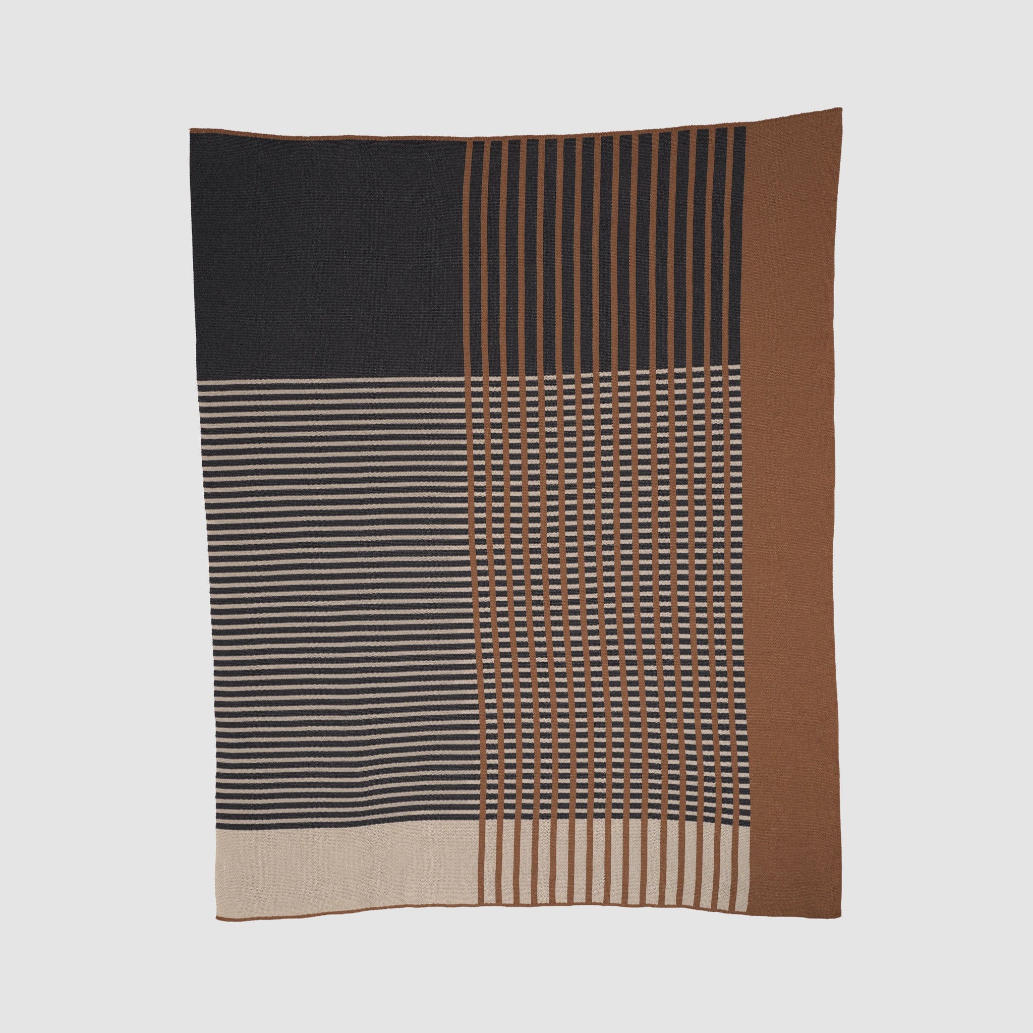 The Overlap Blanket by Kelly Harris Smith is a rectangular throw featuring a geometric design with horizontal, vertical, and grid-like stripes in black, brown, beige, and tan tones—perfect for modern home decor.