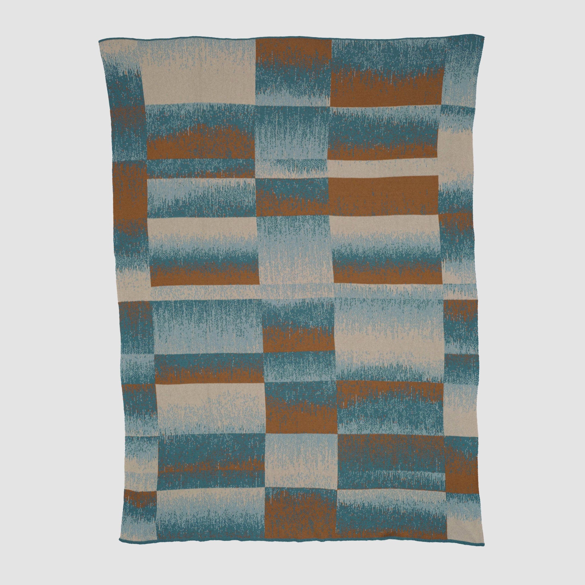 The in2green Plaid Ombre Throw Blanket features a geometric pattern of irregular rectangles in blue, rust, and beige with a soft gradient texture.
