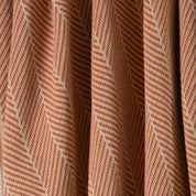 Close-up of the Poly Herringbone Edge Throw Blanket by in2green, featuring a brown and beige herringbone pattern with vertical folds, made from recycled polyester—ideal for outdoor use or cozy interiors.
