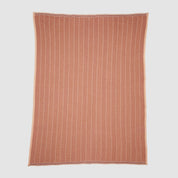 The in2green Poly Herringbone Edge Throw Blanket is a rectangular rust-colored outdoor throw with a white herringbone pattern, made from recycled polyester and shown flat on a white background.