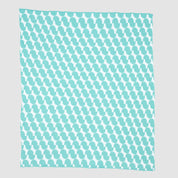 The Poly Juki Throw Blanket by Petra Kaksonen features a rectangular shape with turquoise and white penguin silhouettes in a repeating pattern on a light gray background, inspired by minimalist Scandinavian design.
