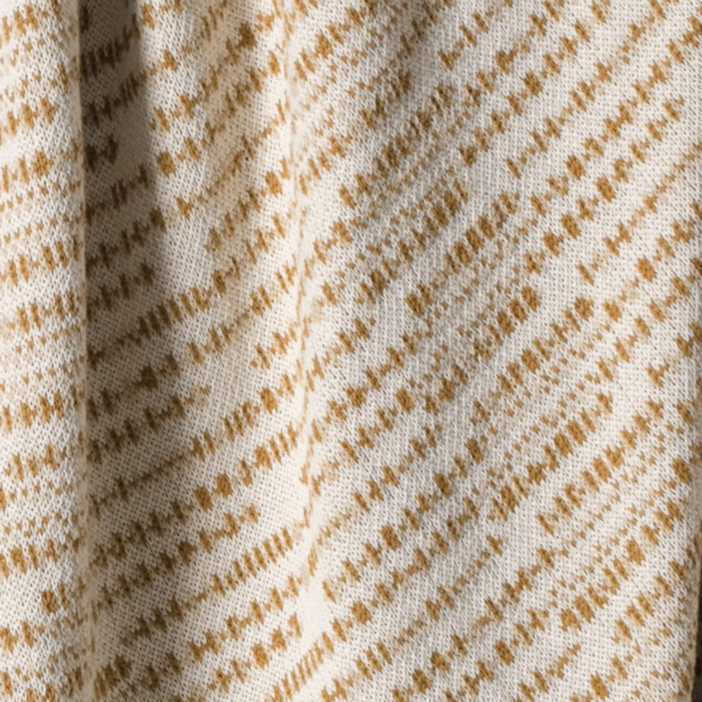 Close-up of fabric with a brown pattern on a beige background