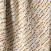 Close-up of fabric with a brown pattern on a beige background