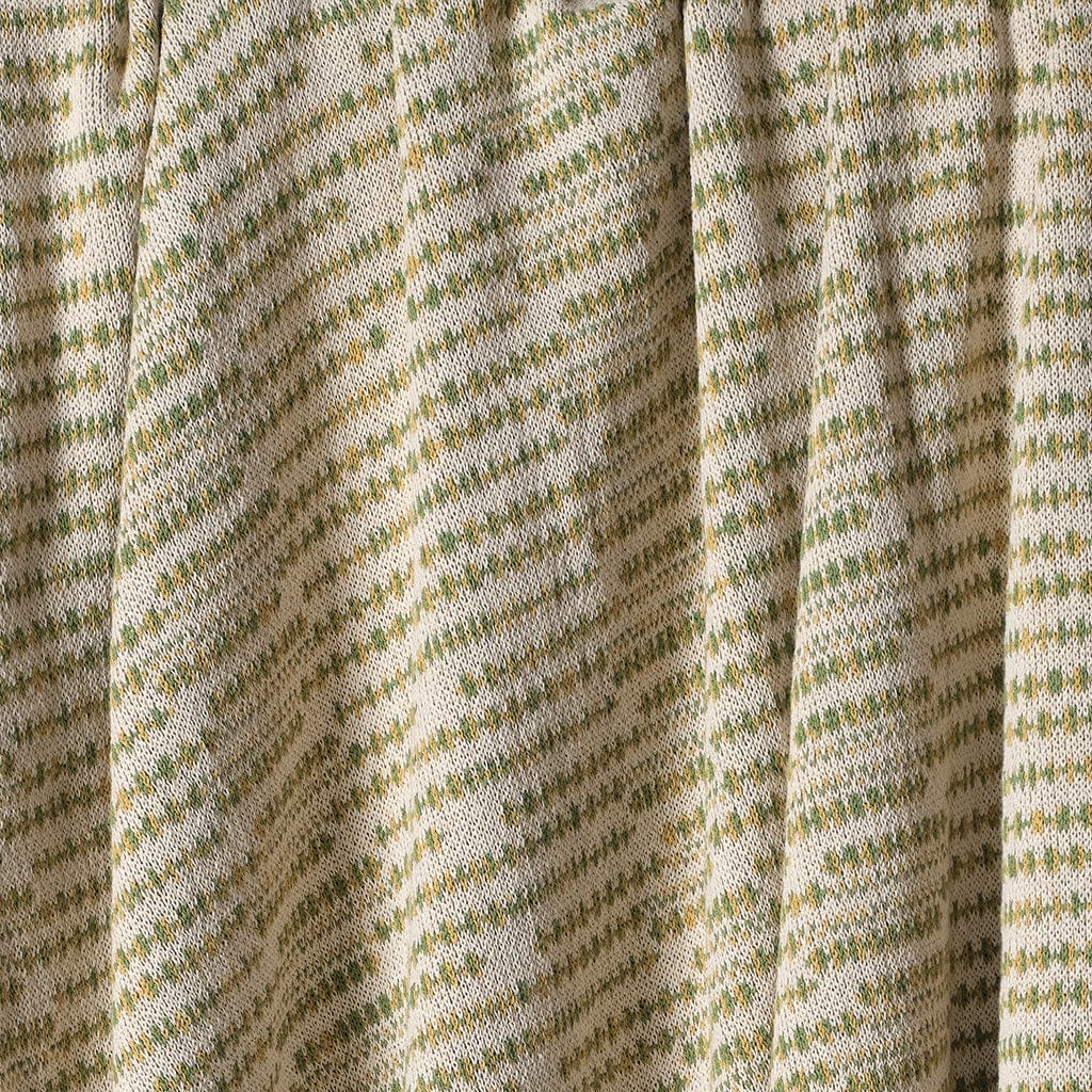 Close-up of a textured fabric with a green pattern