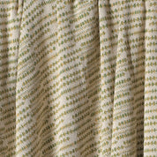 Close-up of a textured fabric with a green pattern