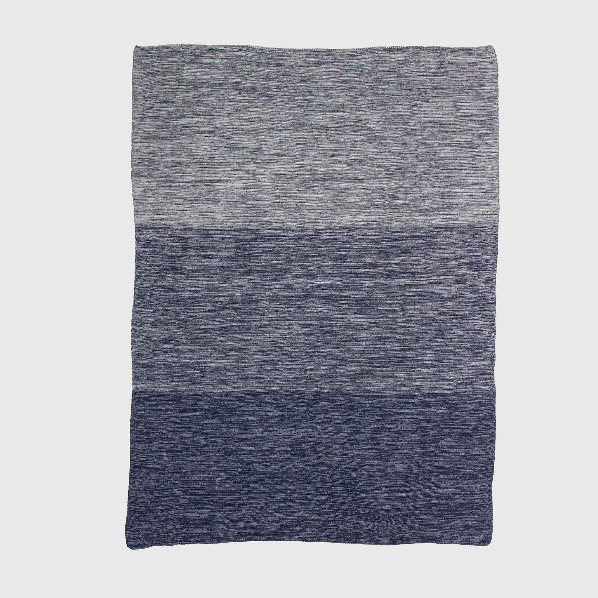 The in2green Textured Ombre Throw Blanket features a ribbed texture with horizontal color blocks in grey and blue, crafted from recycled cotton and shown on a plain white background.