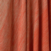 Close-up of the in2green Textured Ombre Throw Blanket in orange and beige, crafted from recycled cotton with diagonal lines and soft ribbed texture.