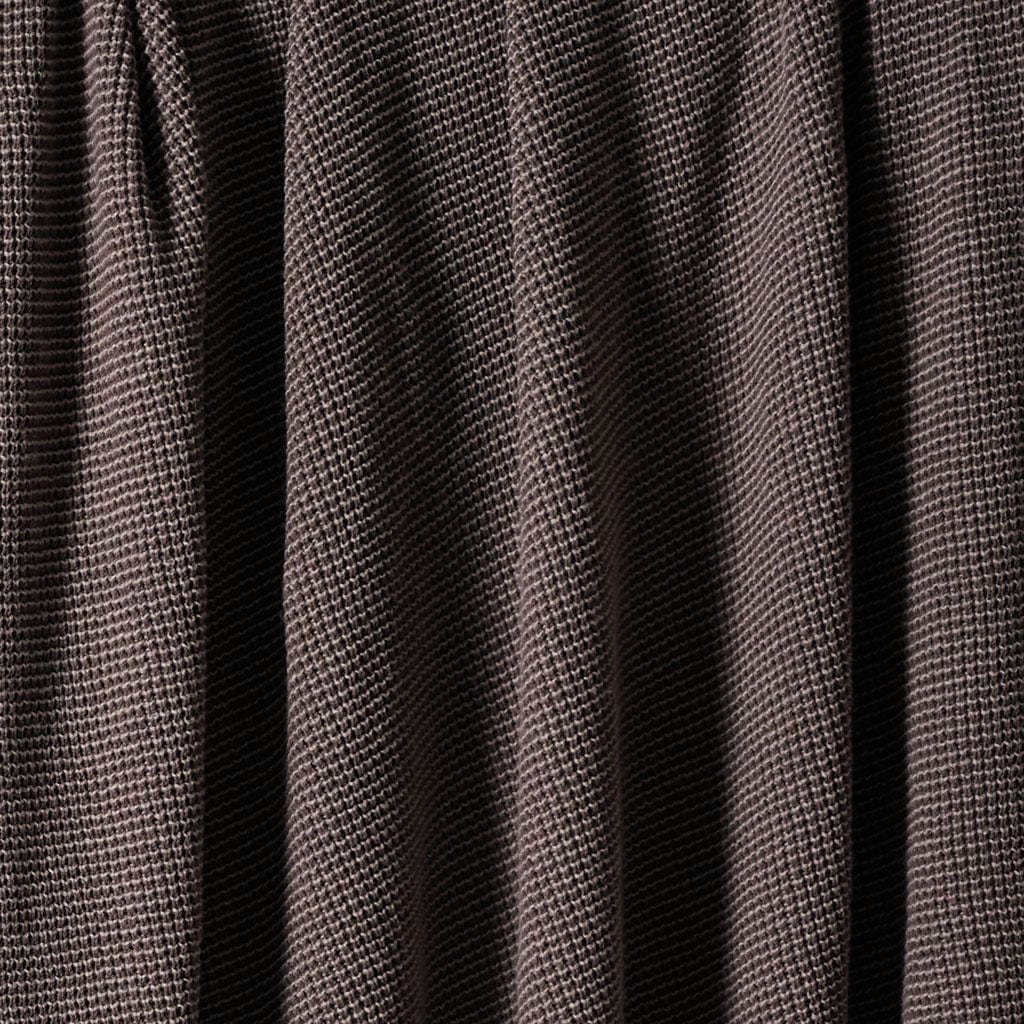 A close-up of the in2green Wool Cardigan Throw Blanket, featuring brown washable wool fabric with vertical folds and a small, repeating square pattern.
