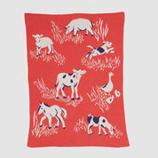 The Baby Farm Blanket by in2green is made from recycled cotton and showcases delightful white and black illustrations of cows, a horse, sheep, a dog, and a duck set against grass patterns.