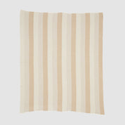 The Herringbone Hues Throw Blanket by In2Green is an eco-friendly creation made from recycled cotton, showcasing a square design with alternating vertical beige and tan stripes on a light background, proudly made in the USA.