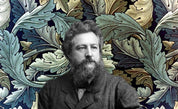 A bearded man in a suit poses elegantly against a vibrant backdrop, evoking the intricate botanical designs of the Arts and Crafts movement, similar to the Larkspur Throw Blanket by William Morris from in2green.