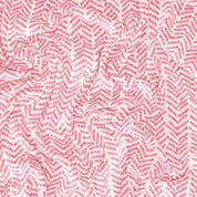 The In2Green Warrior Throw Blanket Pink boasts a striking zigzag pattern in red and white, with a gently crumpled texture, offering both comfort and style for individuals searching for warmth and supporting the breast cancer cause.