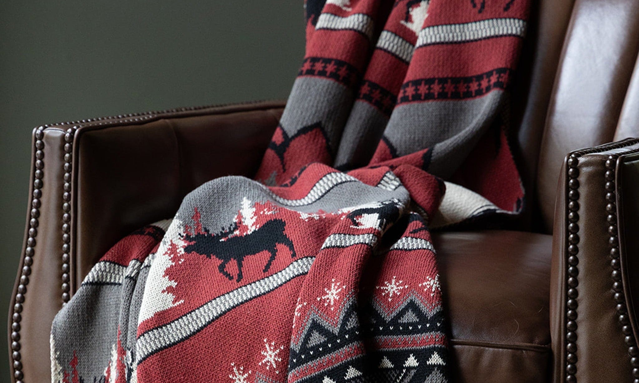 Red Mountain Fair Isle throw blanket on a leather chair
