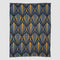 The In2Green Art Deco Shells Throw Blanket is a rectangular luxury throw with a repeating geometric Art Deco pattern in blue, grey, and yellow.