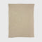 The in2green Basketweave Throw Blanket is a beige, rectangular throw with a subtle checkered pattern made from recycled yarns, shown flat on a white background.