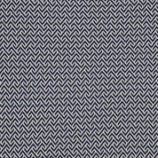 A close-up of the in2green Broken Zig Zag Throw Blanket showcases its repeating navy blue and white geometric zigzag pattern, reminiscent of a chevron design.