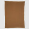 The Checkerboard Throw Blanket, rectangular and brown with a subtle textured pattern, is made from sustainable upcycled cotton and displayed flat on a white background—perfect for cozy living.
