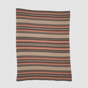 The in2green Geometric Stripe Throw Blanket is crafted from recycled cotton and showcases horizontal brown, tan, and orange patterns. This eco-friendly throw is displayed flat against a plain background.