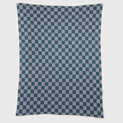 The in2green Gingham Plaid Throw Blanket, featuring a rectangular navy blue and white checkered pattern, is laid flat against a plain background.