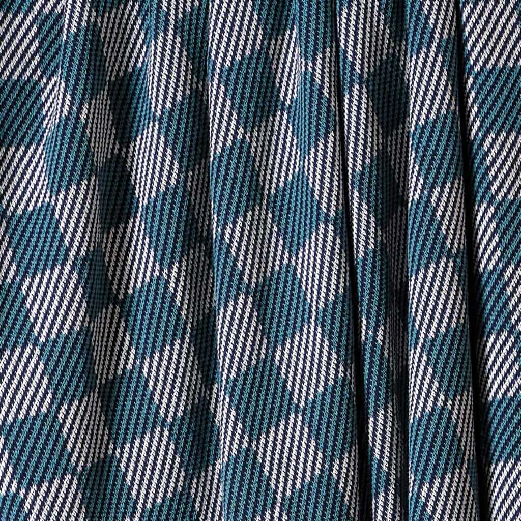 Close-up of in2green's Gingham Plaid Throw Blanket, featuring a blue, white, and black checkered pattern with pleats for a classic look.