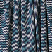 Close-up of in2green's Gingham Plaid Throw Blanket, featuring a blue, white, and black checkered pattern with pleats for a classic look.