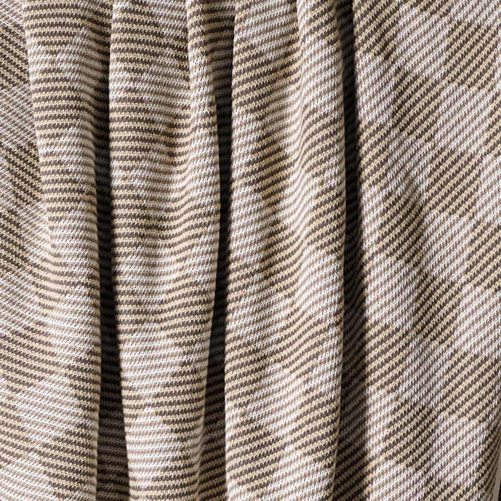 Close-up of the in2green Gingham Plaid Throw Blanket in brown and beige, featuring vertical folds and a cozy woven texture.