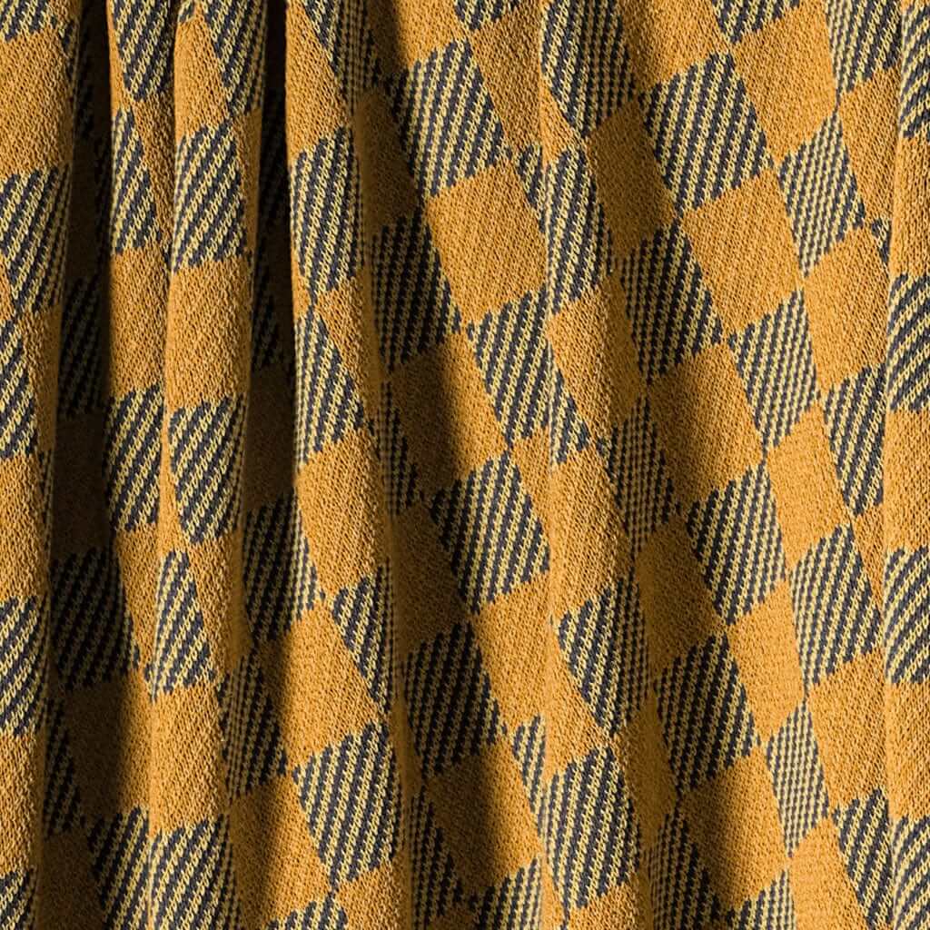 The in2green Gingham Plaid Throw Blanket features a yellow and black checkered design with textured fabric—an eco-friendly, cozy accent perfect for your space.