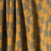The in2green Gingham Plaid Throw Blanket features a yellow and black checkered design with textured fabric—an eco-friendly, cozy accent perfect for your space.