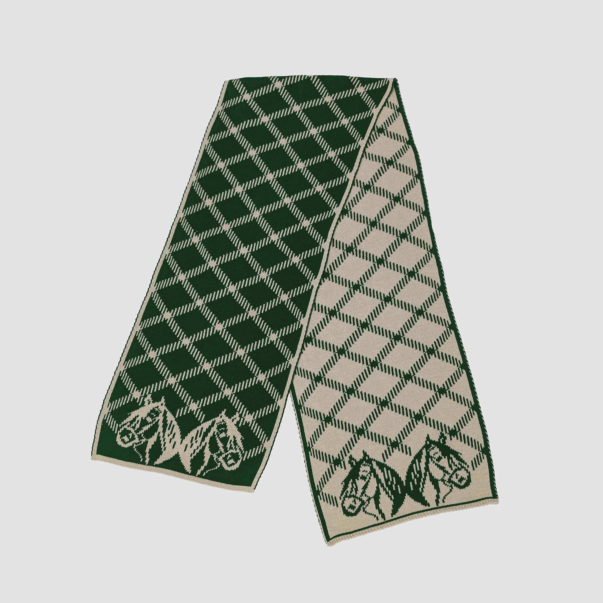 The in2green Equestrian Plaid Scarf is an eco-friendly accessory featuring a green and beige diamond pattern with horse head details at both ends.
