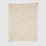 The Matrix Throw Blanket by Elodie Blanchard for in2green is a rectangular, recycled cotton throw featuring vertical black lines and scattered yellow and orange rectangles, shown flat on a light background.