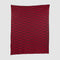 The Riata Throw Blanket by Petra Kaksonen is a rectangular red piece inspired by Scandinavian heritage, showcasing horizontal stripes in alternating dark and bright red on a plain background.