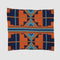 Introducing the Sun Rise Throw Blanket by in2green, a square wool throw featuring a bold geometric design in orange, blue, black, and brown on a crisp white backdrop. Made with care from recycled cotton yarns, this eco-friendly creation brings warmth and style to any space.
