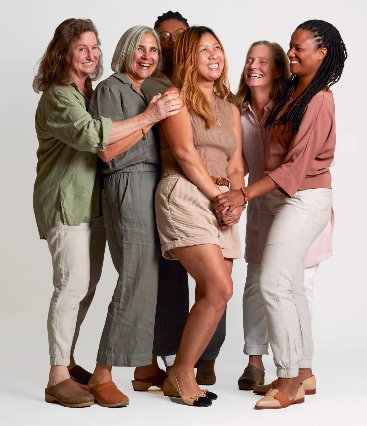 Group of women standing together on a white background