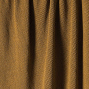 Close-up of the in2green Wool Cardigan Throw Blanket showing its soft, mustard yellow textured fabric with vertically gathered folds.