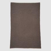 The in2green Wool Cardigan Throw Blanket, a rectangular solid brown piece with a textured surface, is laid flat on a light gray background.