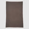 The in2green Wool Cardigan Throw Blanket, a rectangular solid brown piece with a textured surface, is laid flat on a light gray background.