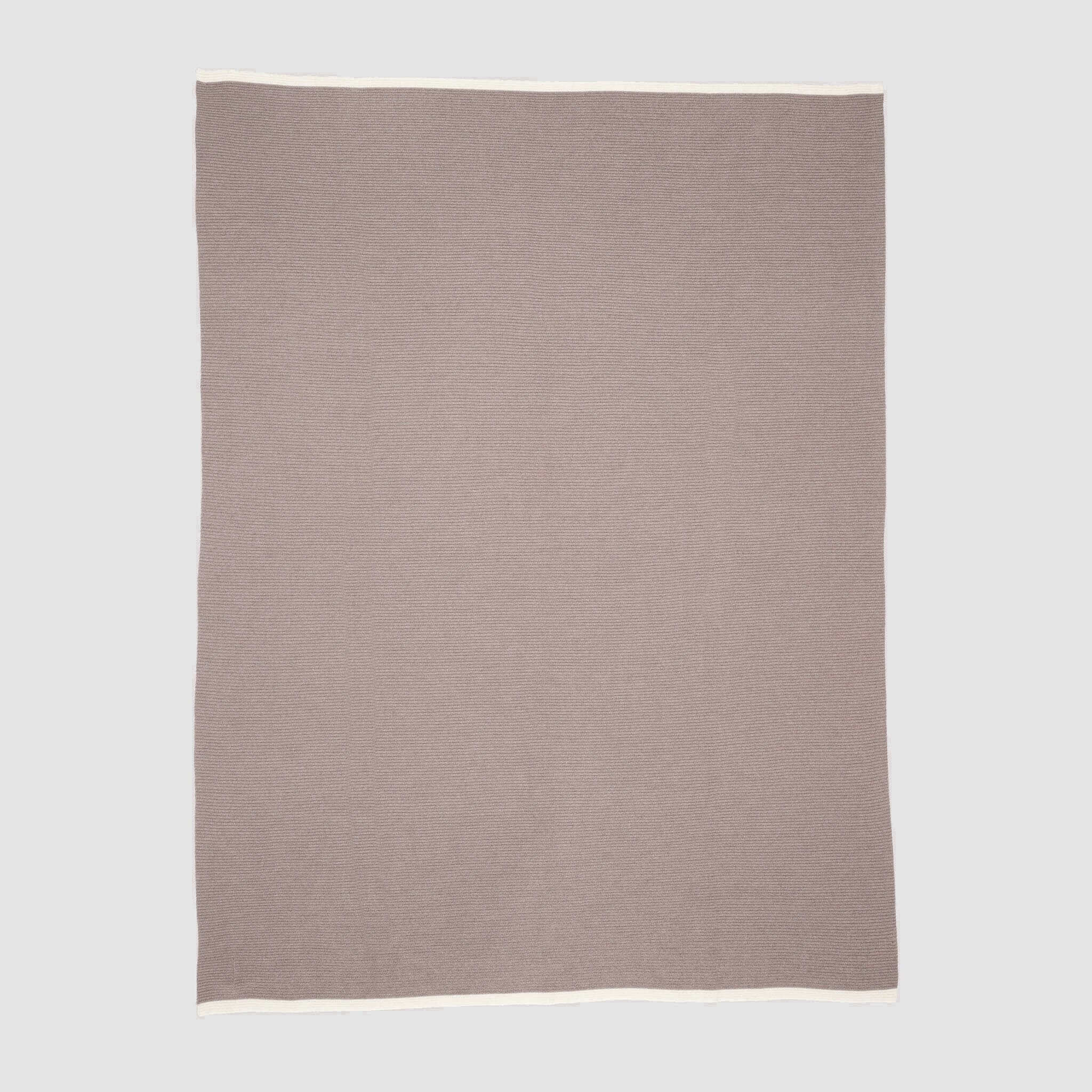The in2green 100% Merino Wool Links Throw Blanket is a minimalist, light brown throw with a white border, crafted from soft wool and displayed flat on a light grey background.