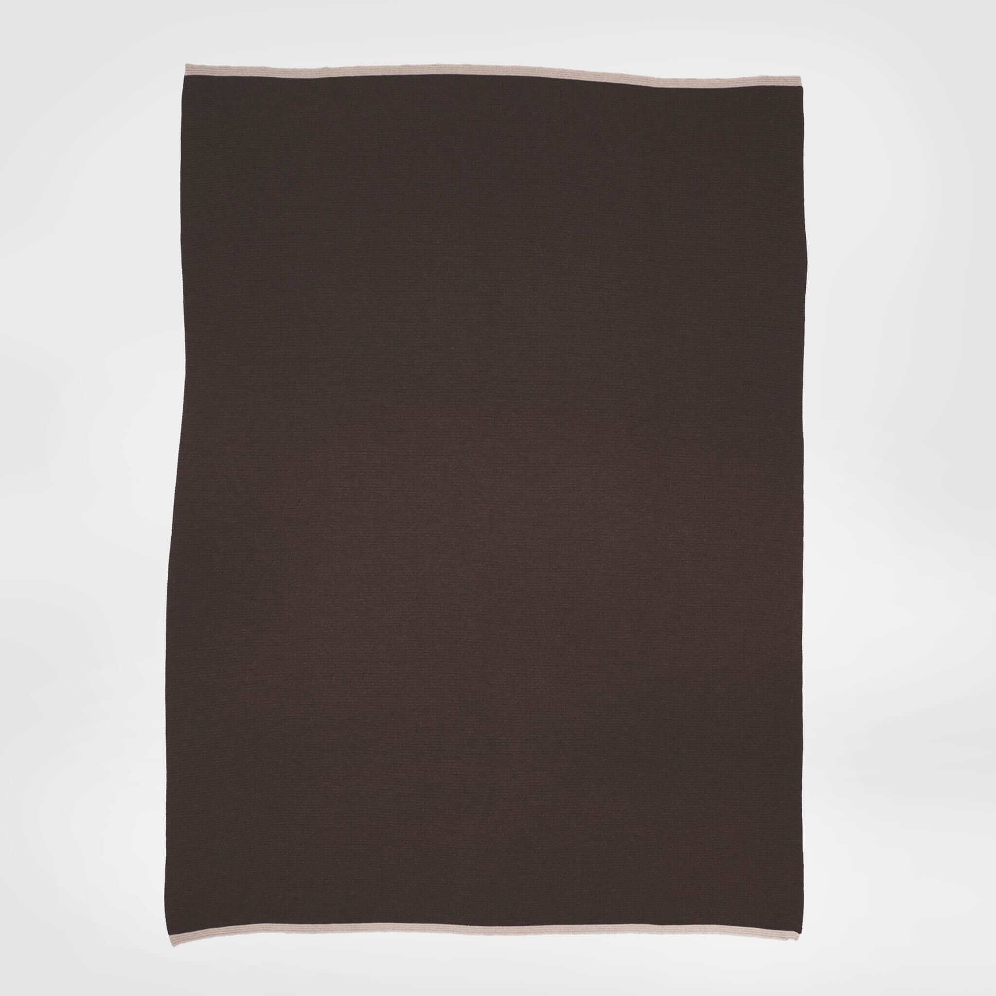 The in2green 100% Merino Wool Links Throw Blanket, a rectangular dark brown luxury throw with light-colored edges, is displayed flat against a plain white background.
