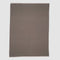 The in2green 100% Merino Wool Links Throw Blanket, shown flat on a white background, features subtle light edges and delivers minimalist elegance in a simple rectangular design.