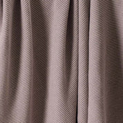 Close-up view of the in2green 100% Merino Wool Links Throw Blanket in beige or taupe, featuring a subtle diagonal textured pattern—an elegant luxury accent for minimalist interiors.