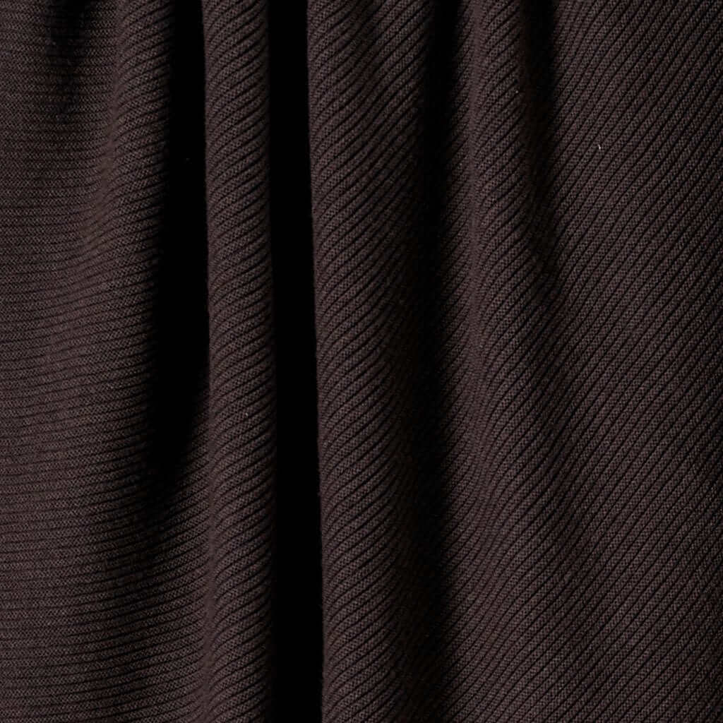 Close-up of the in2green 100% Merino Wool Links Throw Blanket, showcasing its dark brown color, ribbed texture, vertical folds, and richly textured surface.