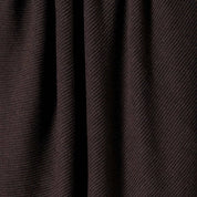Close-up of the in2green 100% Merino Wool Links Throw Blanket, showcasing its dark brown color, ribbed texture, vertical folds, and richly textured surface.